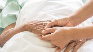 Holding hands in a hospital bed