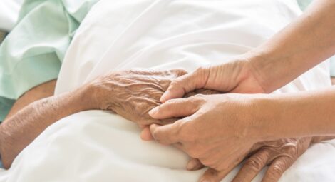 Holding hands in a hospital bed