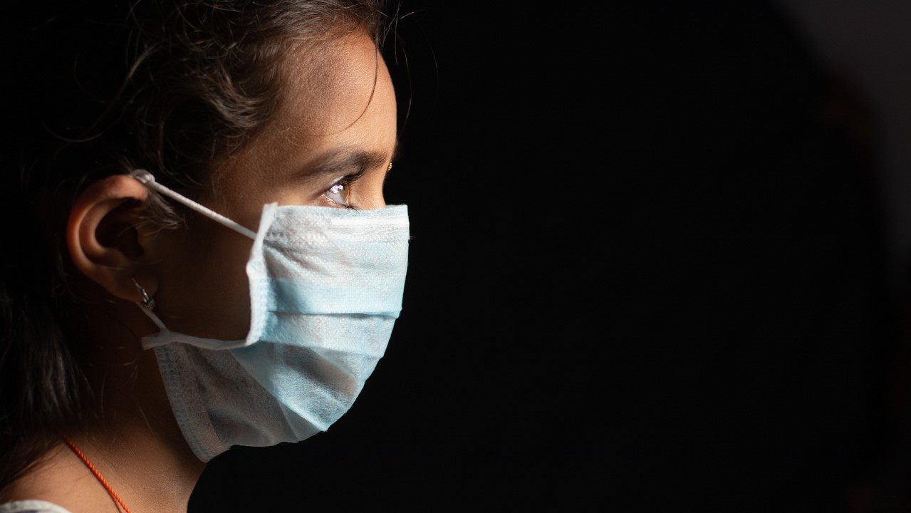 Young girl wearing face mask