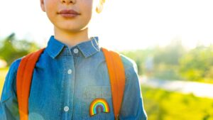 Child wearing a rainbow shirt