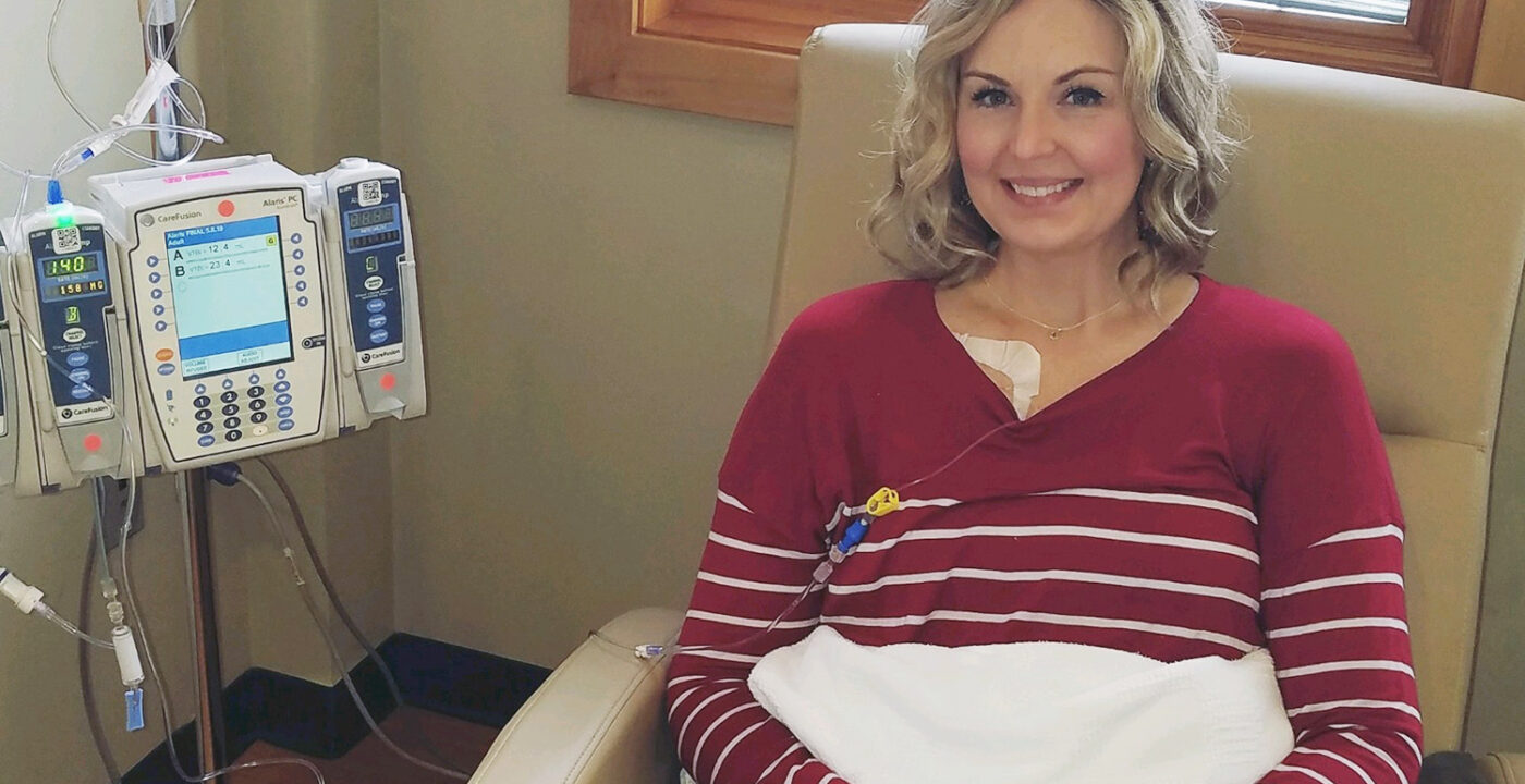 Woman sitting in a hospital chair.