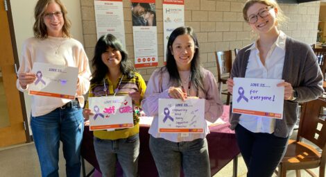 People holding domestic violence awareness signs.