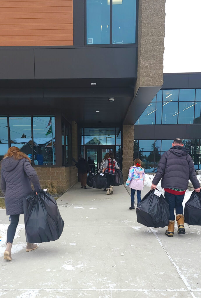 People hauling in toys for a toy drive.