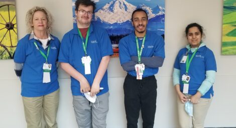 Four volunteers in blue MultiCare shirts