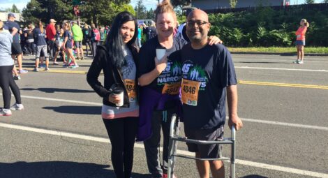 Three runners stand in the street after completing the Sound to Narrows race.