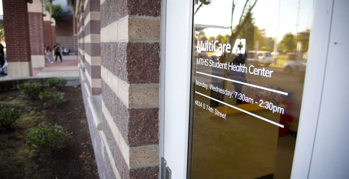 Exterior shot of a door reading “MultiCare MTHS Health Center”
