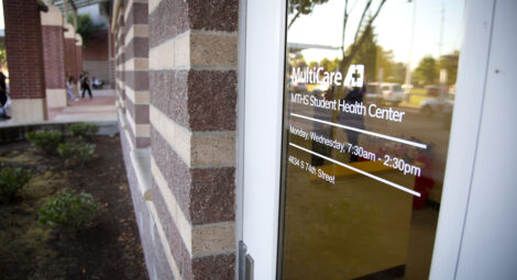 Exterior shot of a door reading “MultiCare MTHS Health Center”