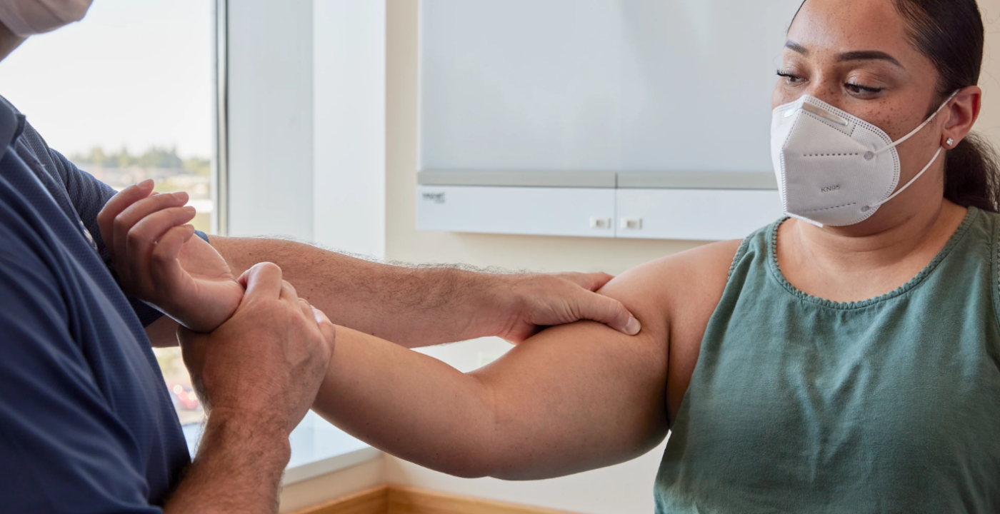 Medical provider performs a shoulder and arm exam on a patient