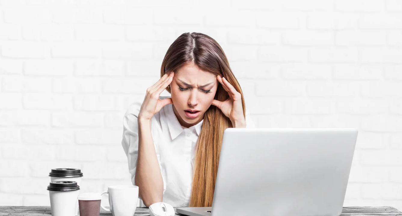 Woman looking stressed in front of laptop