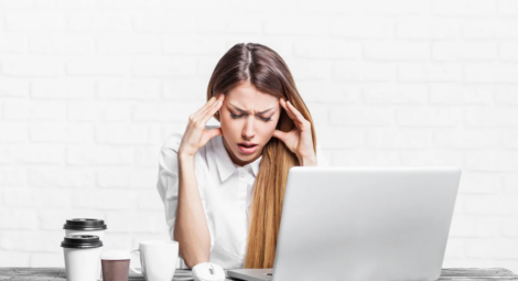 Woman looking stressed in front of laptop