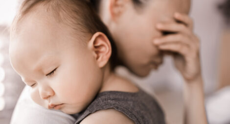 Tired mom holding baby