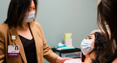 Doctor talking to patient in exam room