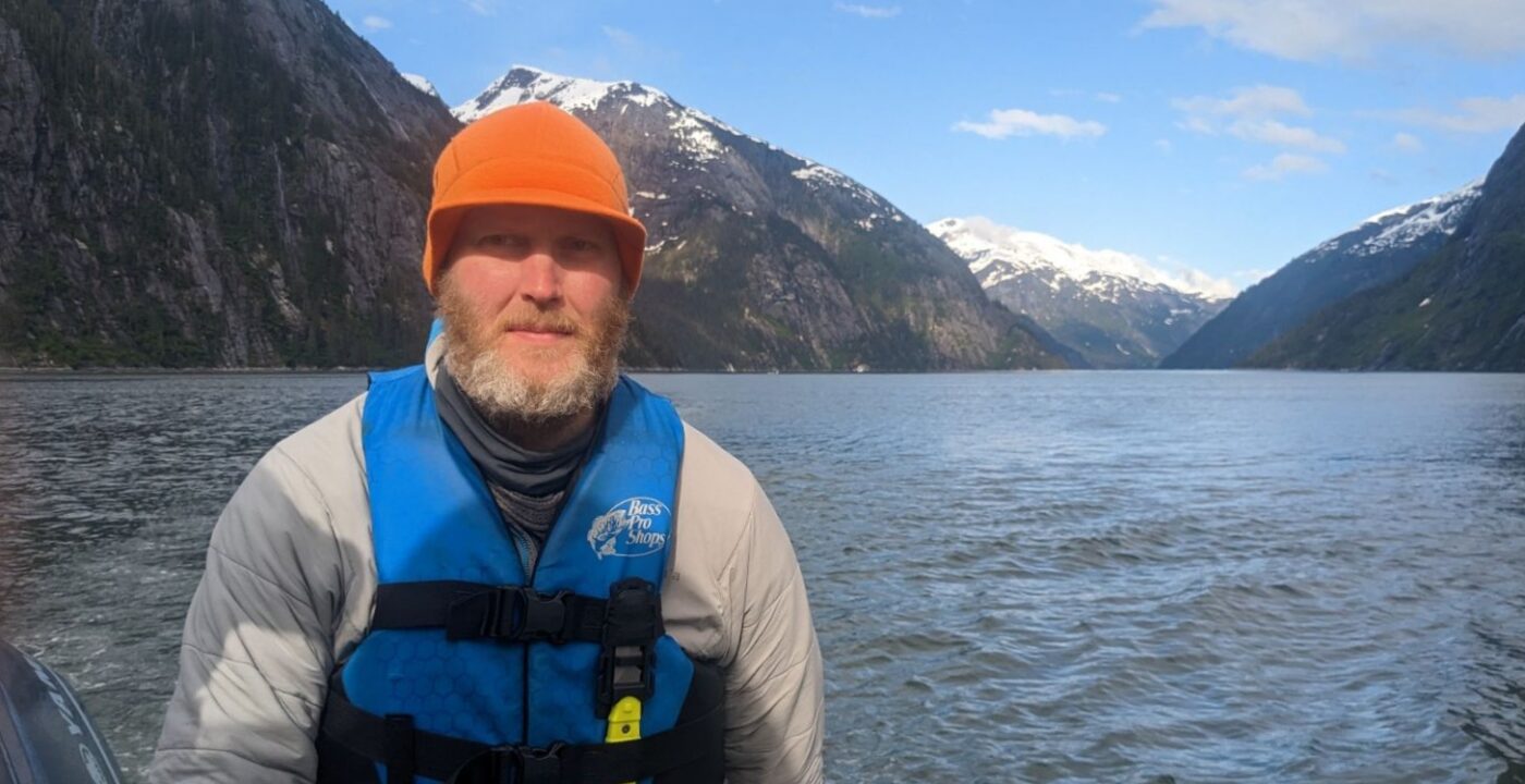 A man wearing a helmet on a lake.