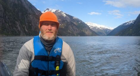 A man wearing a helmet on a lake.