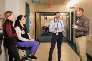 Doctor standing in a hallway.