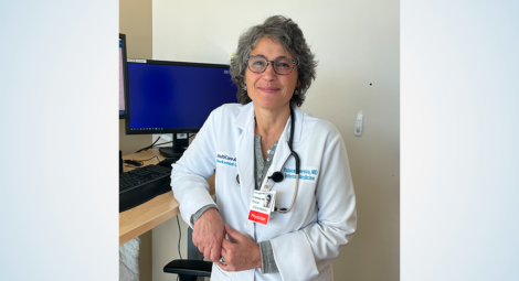 Female doctor standing at computer desk