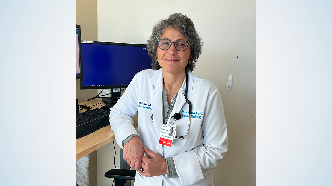 Female doctor standing at computer desk