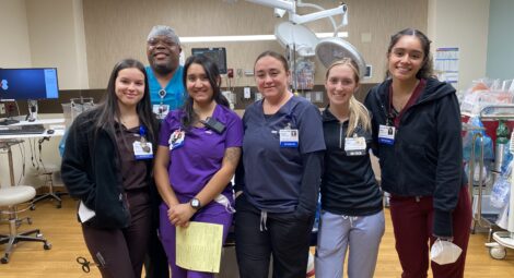 Group of emergency services technicians standing in the trauma room of a hospital