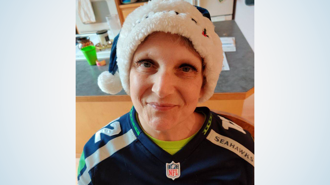 Woman wearing Seahawk gear.