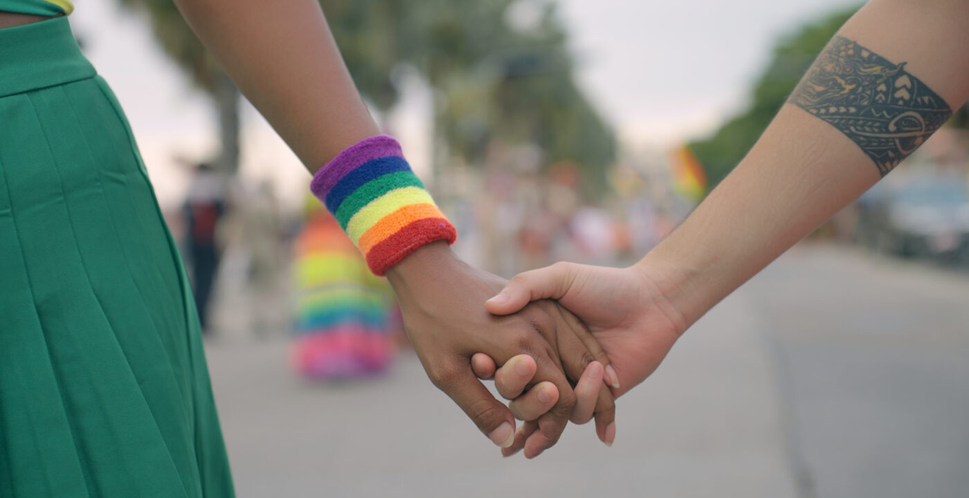 Two young women holding hands