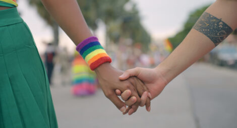 Two young women holding hands