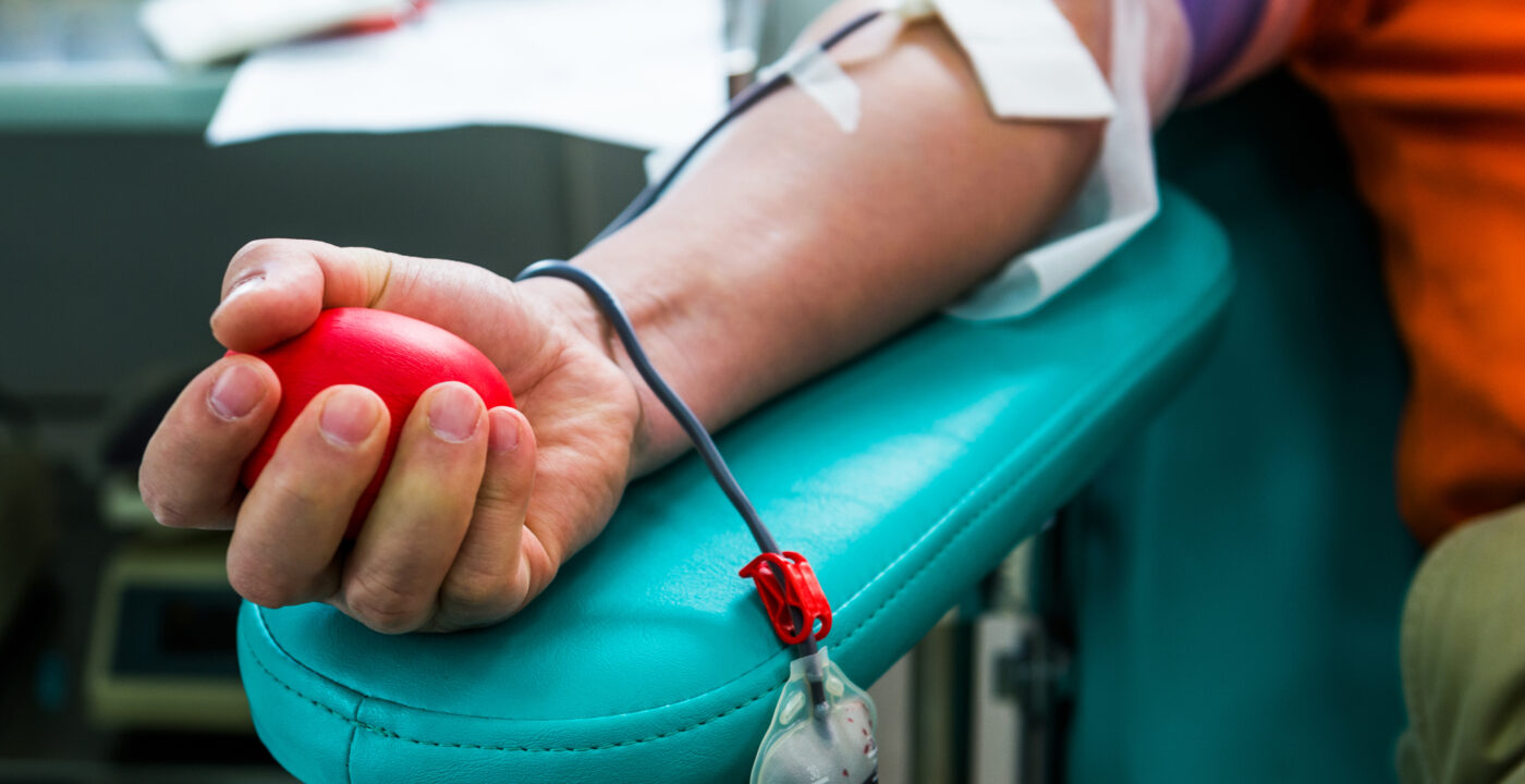 Hand grabbing a stress ball to give blood.
