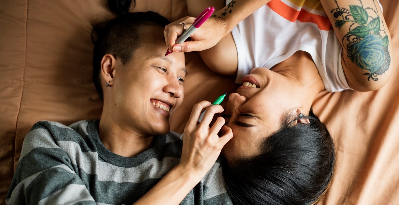 Two people laying in bed.