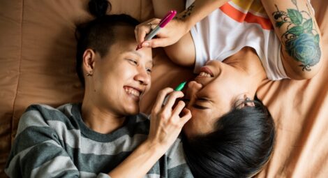 Two people laying in bed.