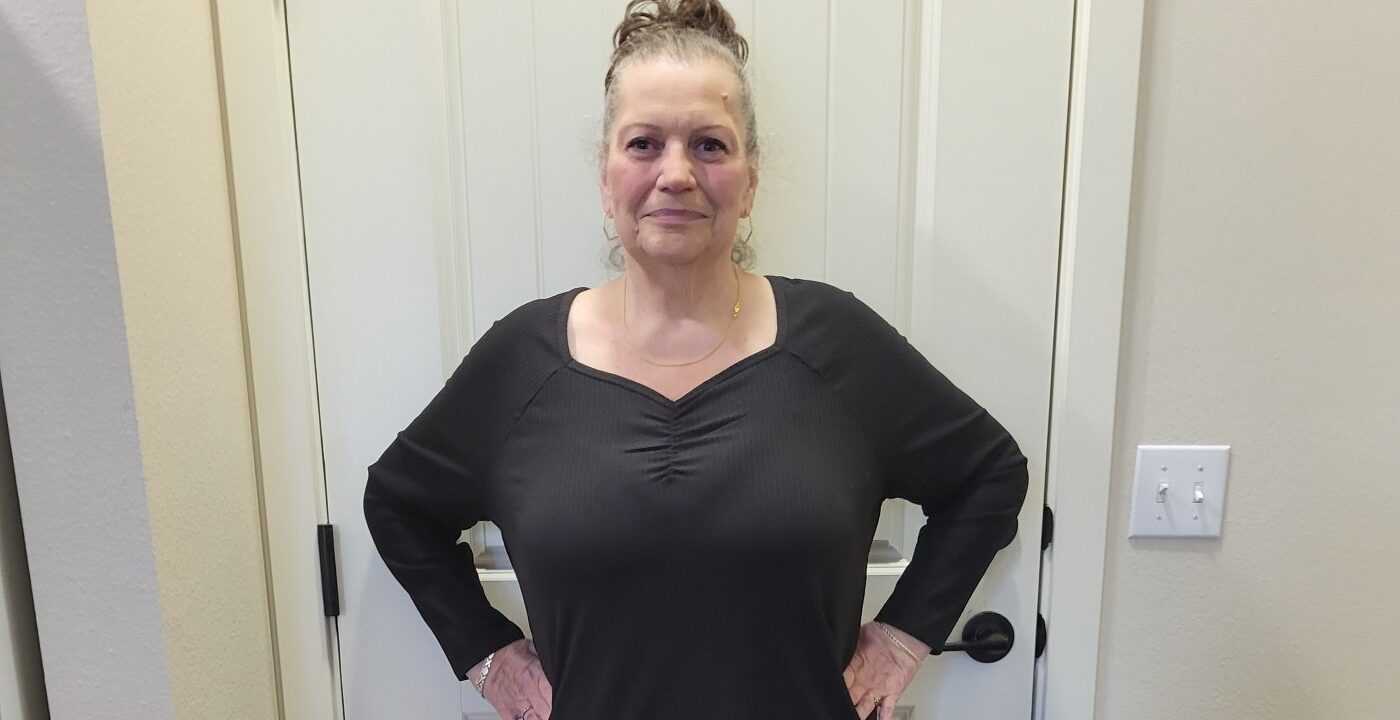 Woman posing to show weight loss.