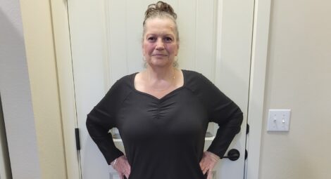 Woman posing to show weight loss.