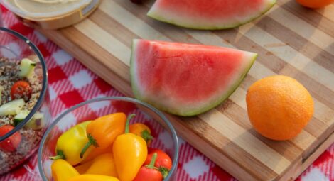 Picnic blanket spread with fruits and veggies