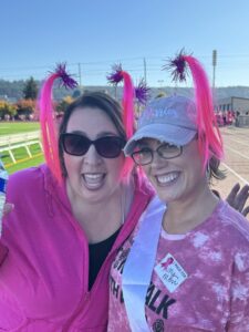 Two women in pink posing.