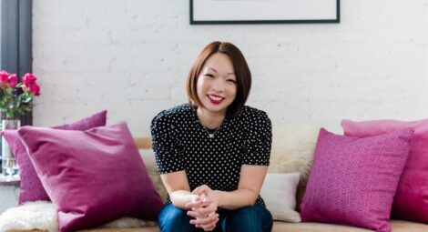 Tamara Chang, MD, sits on a couch with pink pillows