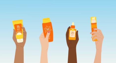 Four hands holding up different types and SPF levels of sunscreen bottles