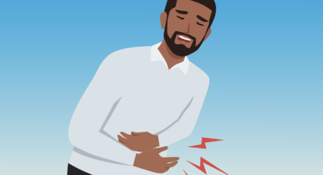 Man holds his abdomen in pain