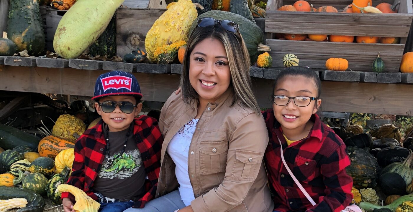 Woman sitting with two children.
