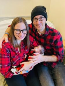 Family posing with new born baby.