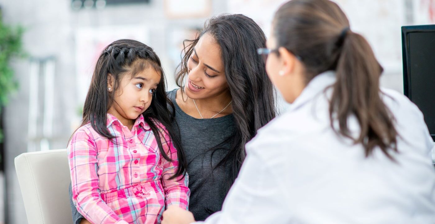 Mother and her young daughter talking with a provider