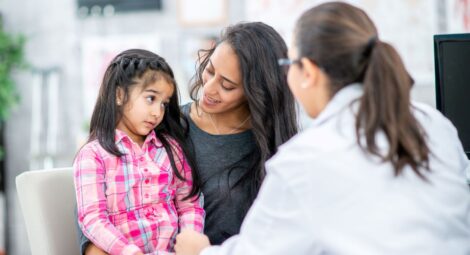 Mother and her young daughter talking with a provider