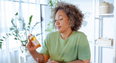 Woman examines pill bottle