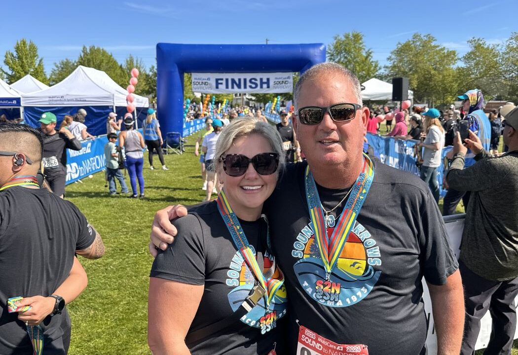 Woman and man in Sound to Narrows shirts near the race finish line