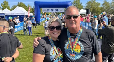 Woman and man in Sound to Narrows shirts near the race finish line