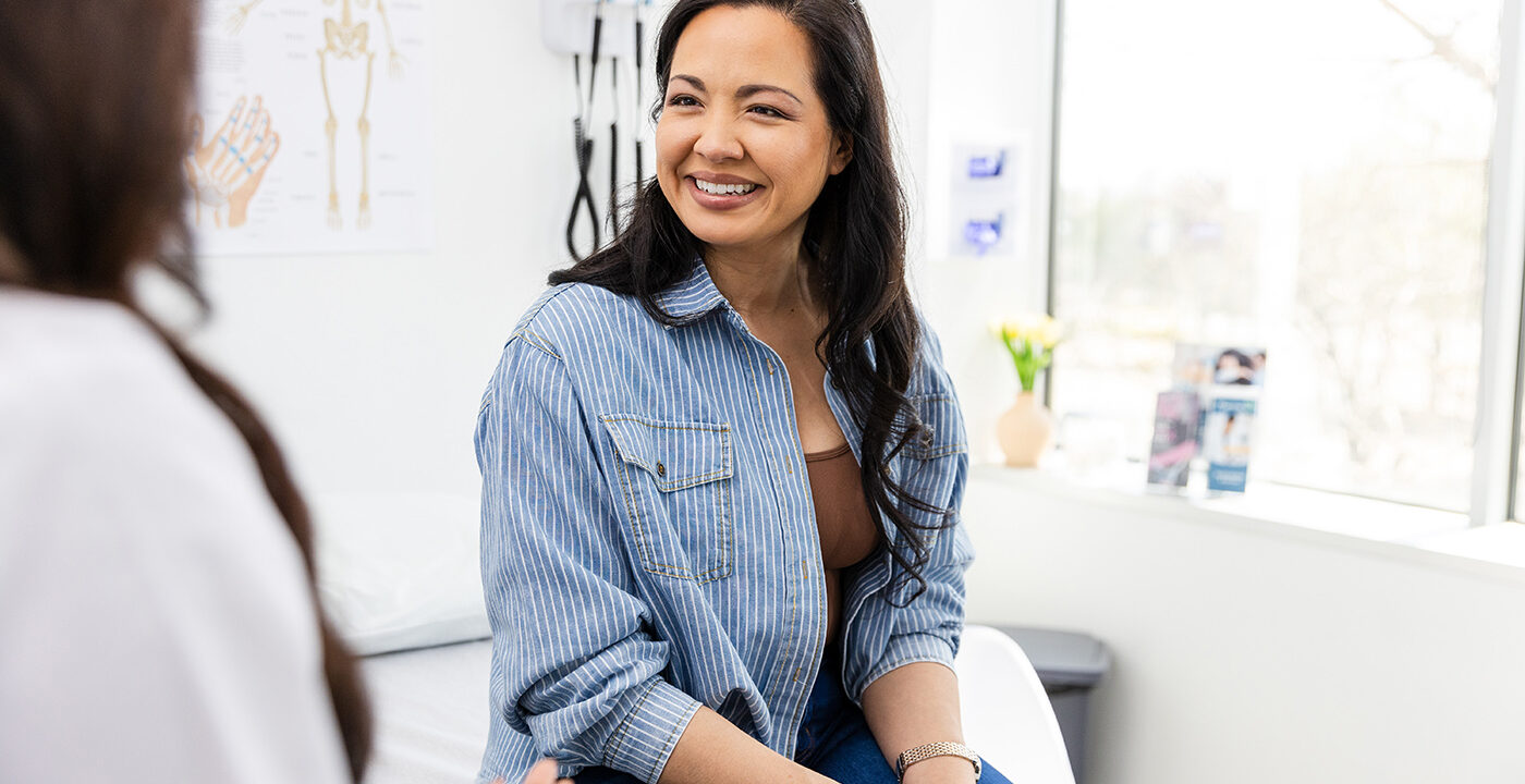 Woman talking to doctor.