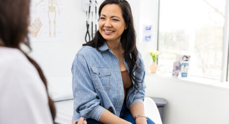 Woman talking to doctor.