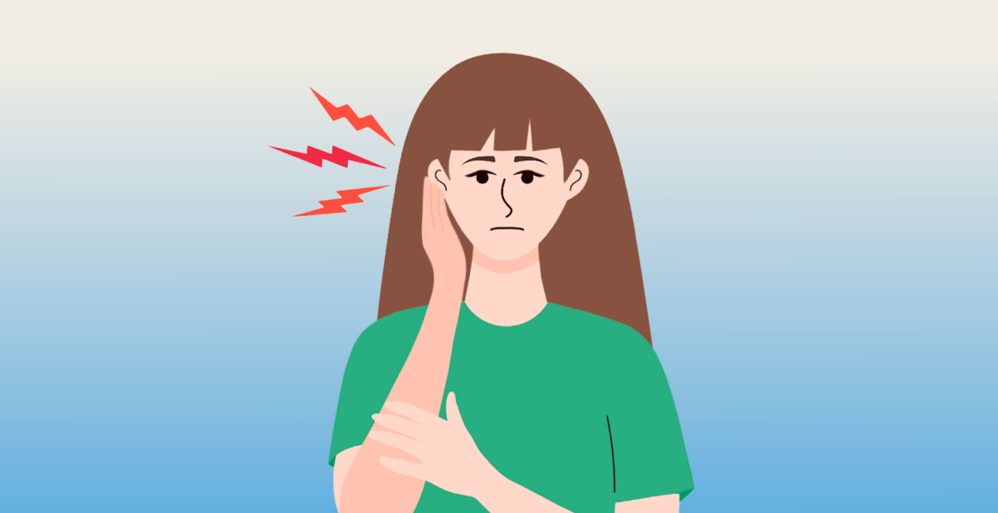 Woman holding hand over ear in discomfort