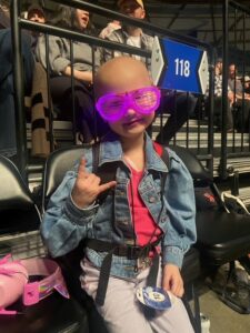 Young girl wearing purple/pink glasses