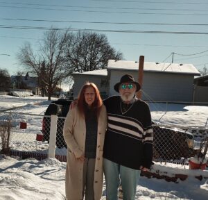 Man and woman standing in the snow.