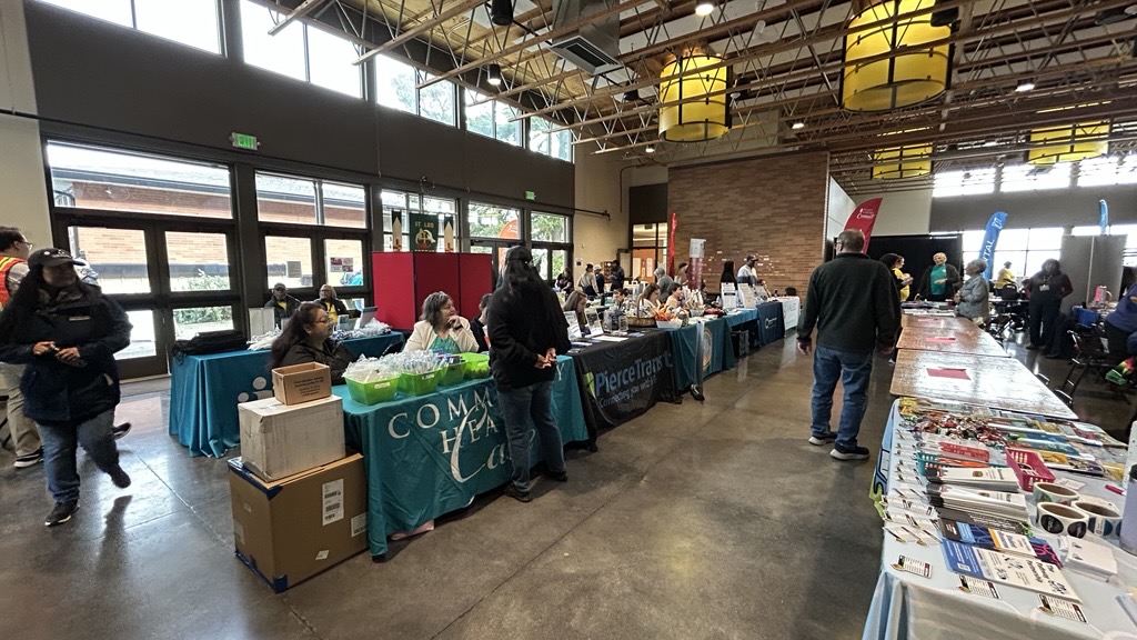 People walk through rows of vendor tables