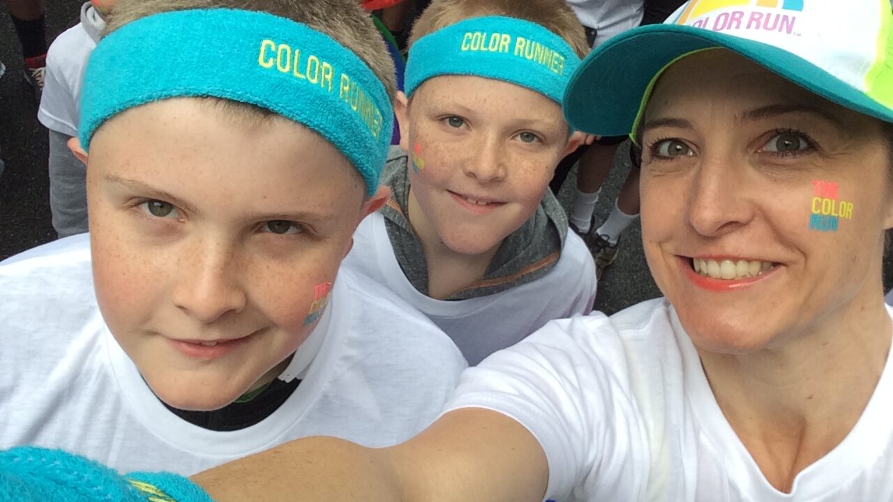 Woman and two young boys in Color Run gear