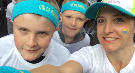 Woman and two young boys in Color Run gear